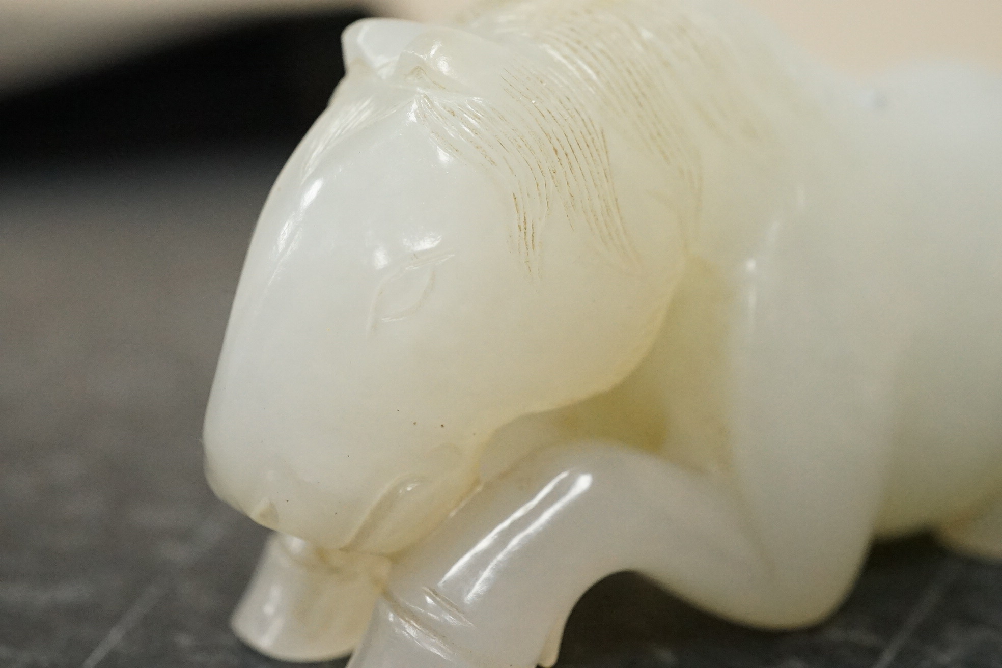 A Chinese white jade figure of a recumbent horse